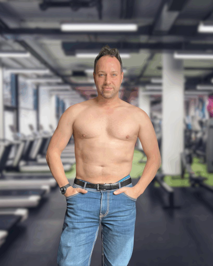 Online Personal Trainer David Todd standing in a gym with a pair of blue jeans