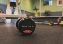 A line of professional dumbbells in the David Todd Fitness pT Studio with a slate wall